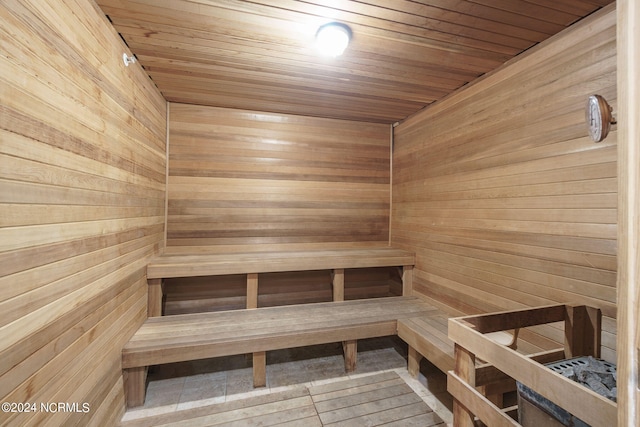 view of sauna with wooden walls and wood ceiling