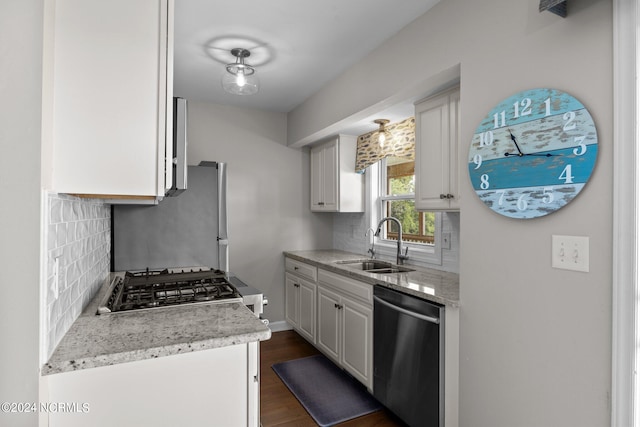 kitchen featuring sink, white cabinets, stainless steel appliances, backsplash, and dark hardwood / wood-style flooring