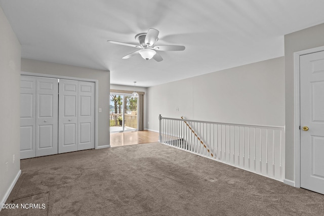 unfurnished bedroom featuring access to outside, carpet flooring, and ceiling fan