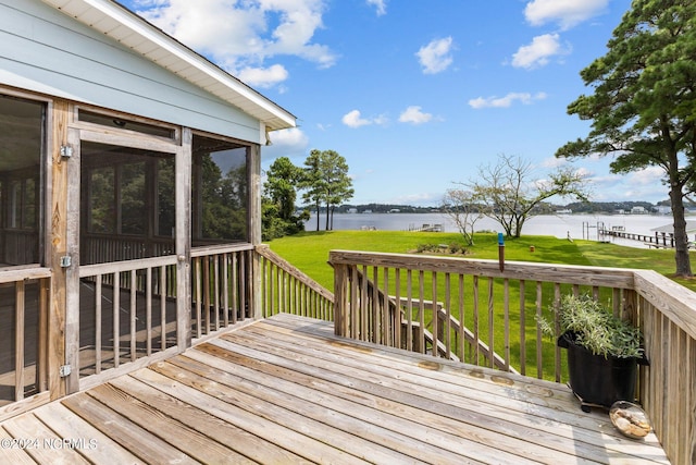 deck featuring a sunroom, a yard, and a water view