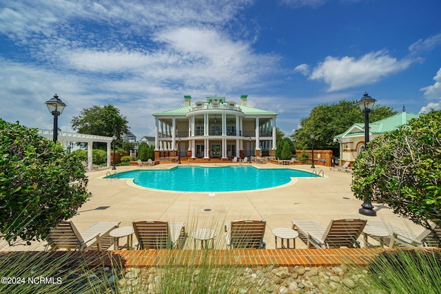 view of pool with a pergola and a patio