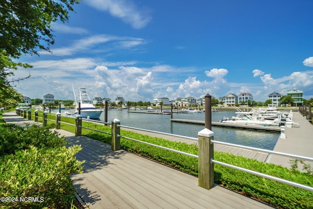 wooden deck with a water view and a dock