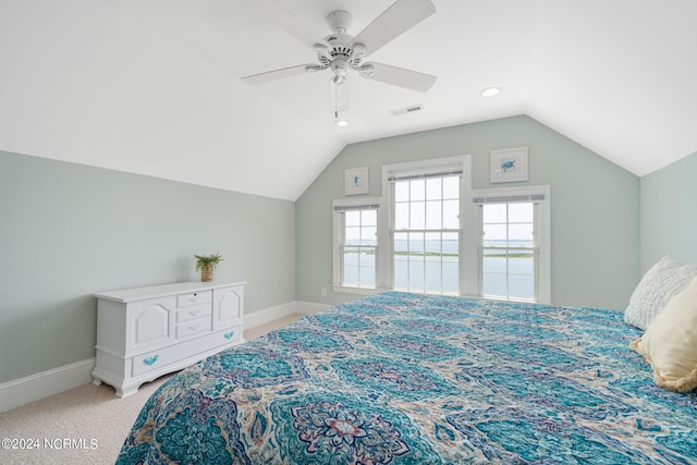 carpeted bedroom with vaulted ceiling and ceiling fan