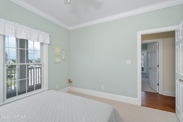 bedroom with crown molding and carpet