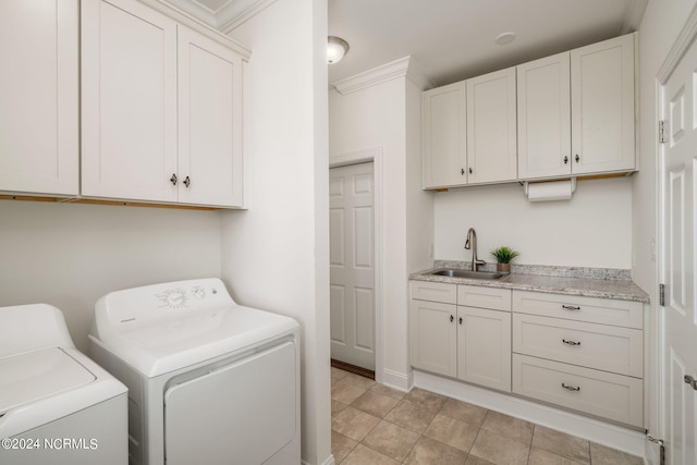 washroom featuring cabinets, separate washer and dryer, and sink