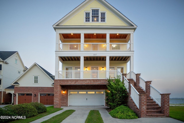 view of front facade featuring a garage and a balcony