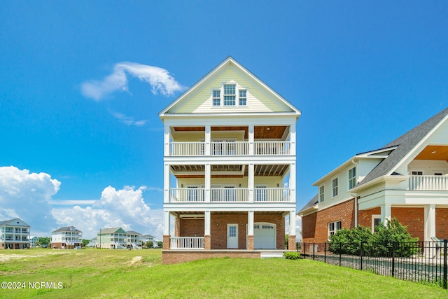 rear view of property featuring a balcony and a lawn