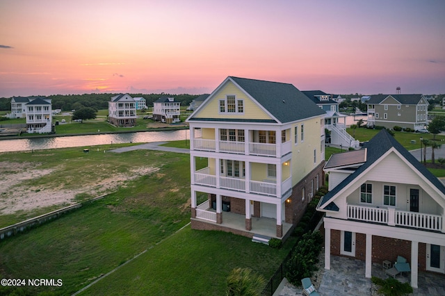 aerial view at dusk with a water view