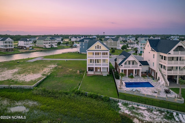 aerial view at dusk with a water view