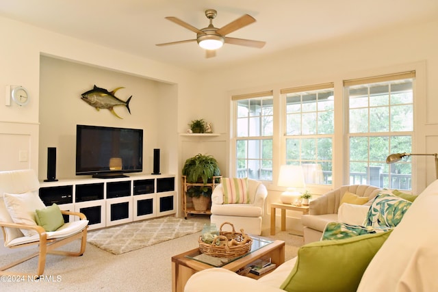 carpeted living room featuring ceiling fan