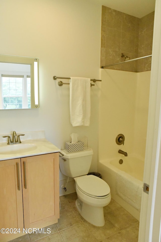 full bathroom featuring tile patterned floors, toilet, tiled shower / bath combo, and vanity