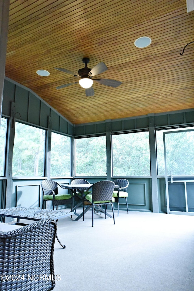 sunroom / solarium featuring wooden ceiling and ceiling fan