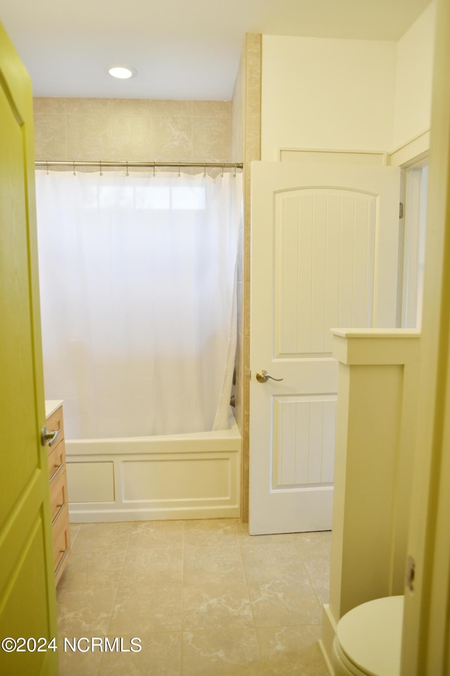 full bathroom with vanity, shower / tub combo, and toilet