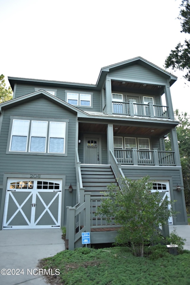 view of front facade with a garage and a porch