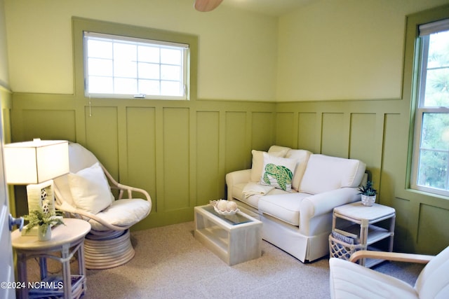 sitting room featuring a healthy amount of sunlight and carpet flooring