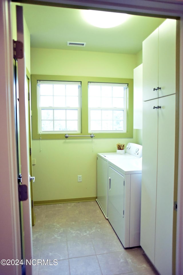 laundry area featuring cabinets and washer and clothes dryer