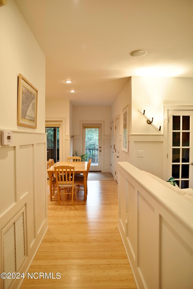 hallway with light hardwood / wood-style flooring