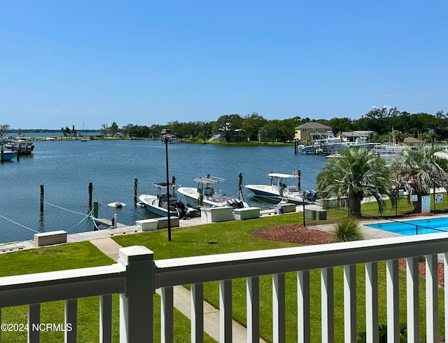 exterior space with a community pool and a water view