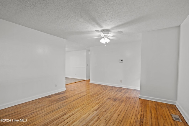 unfurnished room with a textured ceiling, light hardwood / wood-style flooring, and ceiling fan