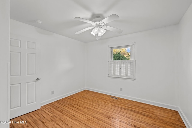 empty room with ceiling fan and light hardwood / wood-style floors