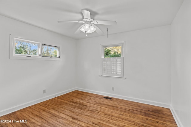 empty room featuring hardwood / wood-style flooring and ceiling fan