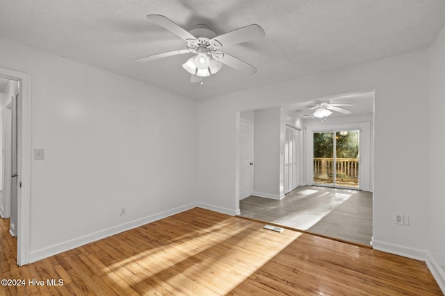 spare room with ceiling fan, wood-type flooring, and a textured ceiling