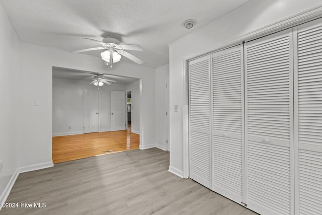 interior space with light hardwood / wood-style floors and a textured ceiling