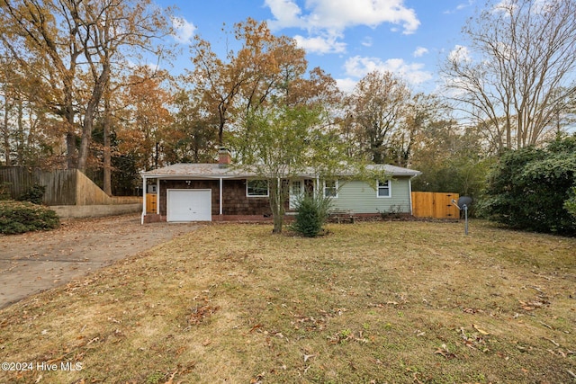 ranch-style home featuring a garage and a front yard