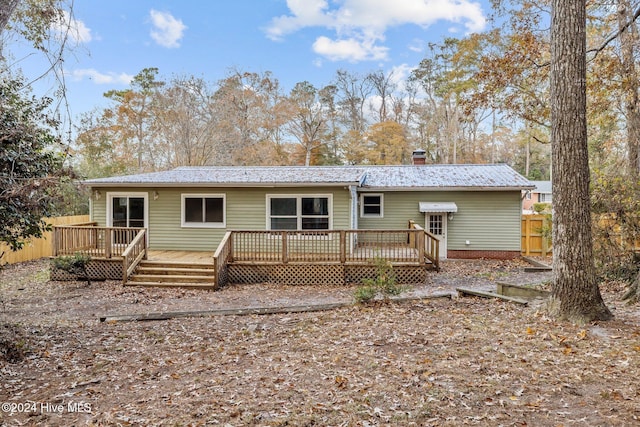 back of house with a wooden deck