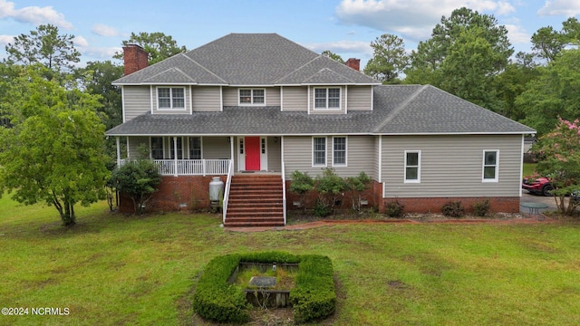 view of front of house with covered porch and a front yard