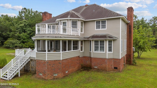 view of front facade with a wooden deck and a front yard