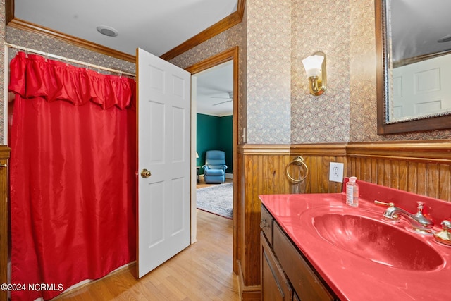 bathroom with ornamental molding, vanity, and hardwood / wood-style flooring