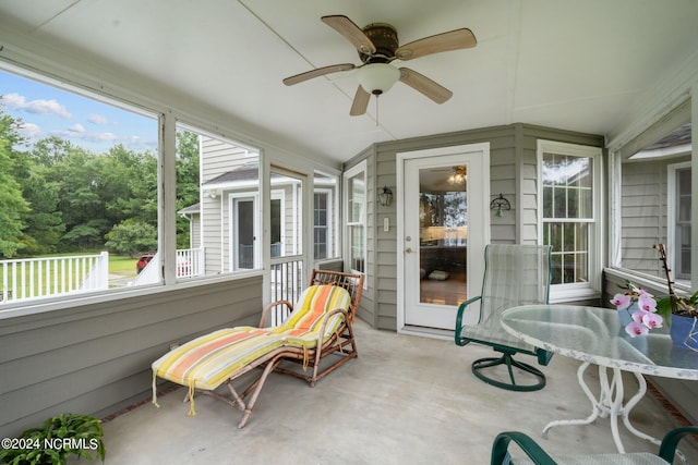 sunroom / solarium with a wealth of natural light and ceiling fan