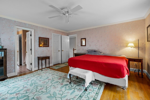 bedroom with hardwood / wood-style flooring, crown molding, and ceiling fan