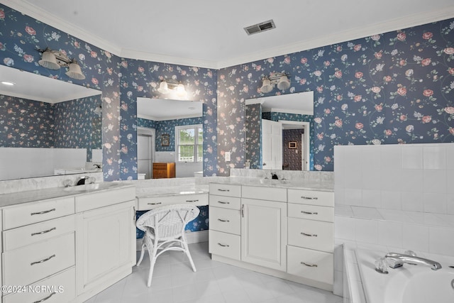 bathroom featuring vanity, crown molding, a bathtub, and tile patterned floors