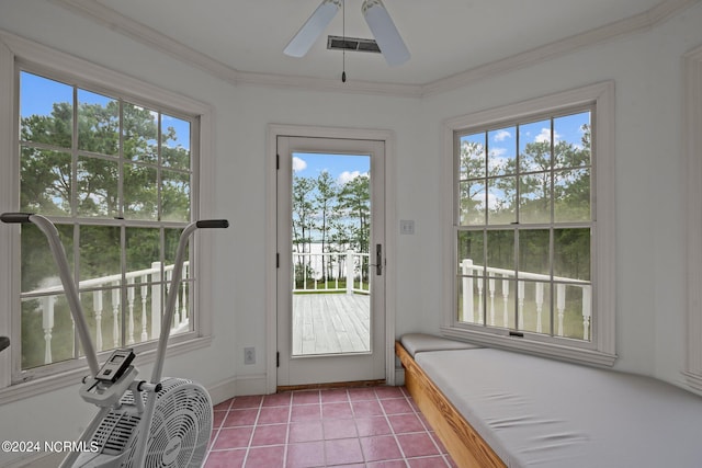 doorway to outside with plenty of natural light, tile patterned flooring, ceiling fan, and ornamental molding