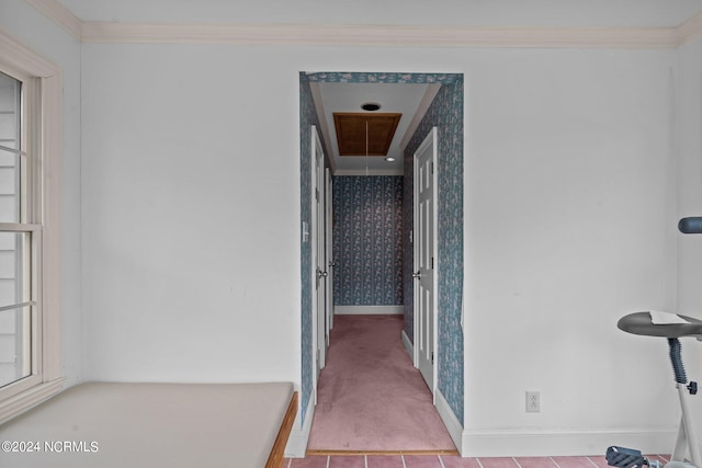 hallway featuring light tile patterned flooring and crown molding