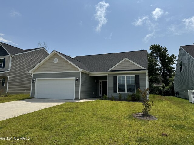 view of front of house with a garage and a front yard