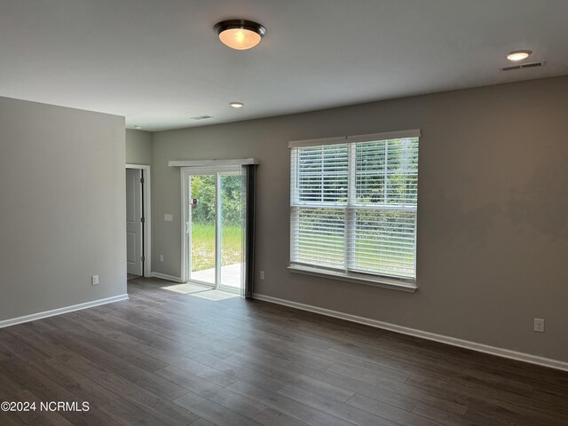 unfurnished room with wood-type flooring