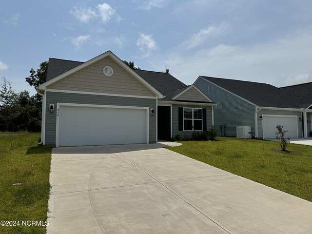 single story home with a garage, a front lawn, and cooling unit