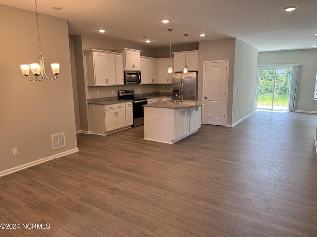 kitchen with white cabinetry, dark hardwood / wood-style flooring, an island with sink, appliances with stainless steel finishes, and decorative light fixtures