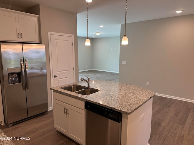 kitchen featuring appliances with stainless steel finishes, white cabinets, sink, pendant lighting, and dark wood-type flooring