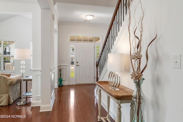 foyer featuring dark wood-type flooring and ornamental molding