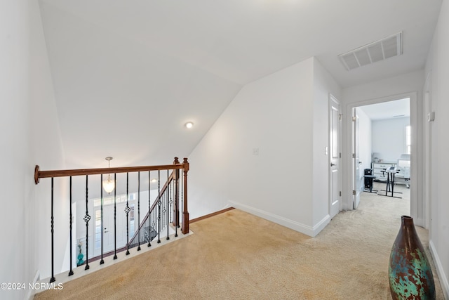 hall with light carpet and lofted ceiling