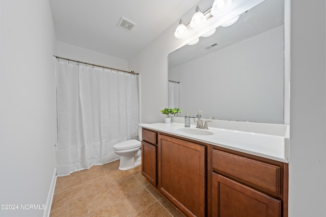 bathroom featuring tile patterned flooring, vanity, and toilet