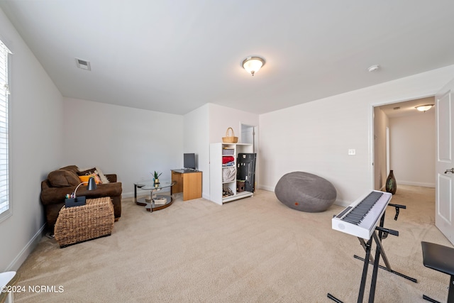 living area with light carpet