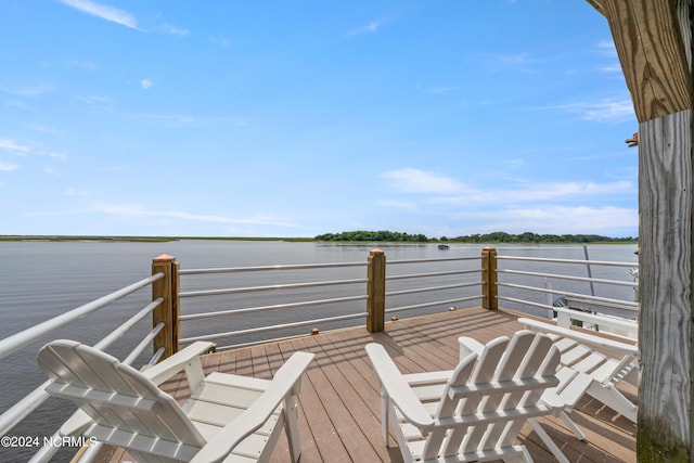 wooden terrace featuring a water view