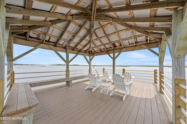 view of dock with a gazebo and a deck with water view