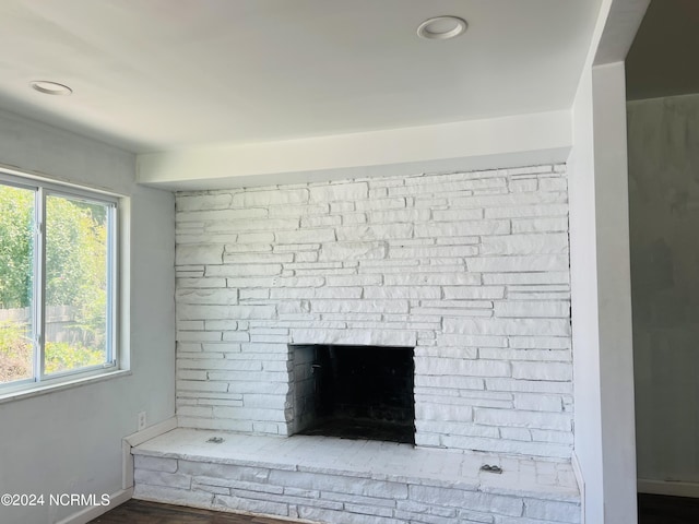 interior details with a fireplace with raised hearth and baseboards