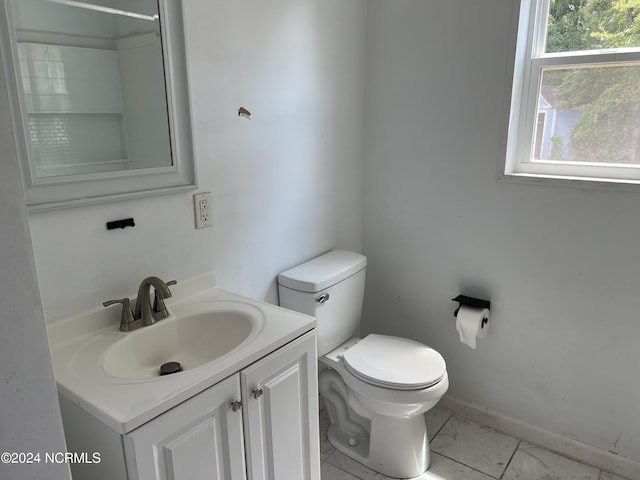 bathroom with toilet, marble finish floor, baseboards, and vanity